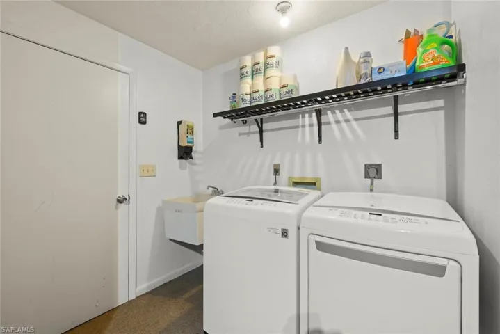 Clothes washing area with sink and washer and clothes dryer