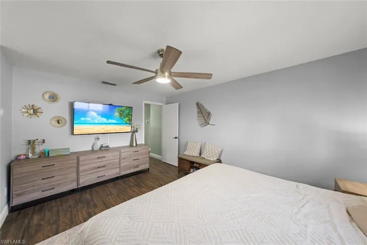 Bedroom featuring dark wood-type flooring and ceiling fan