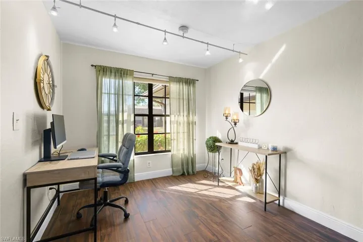Office area featuring track lighting and dark hardwood / wood-style floors