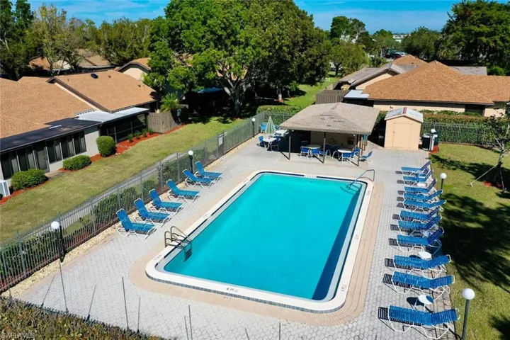 View of swimming pool featuring a patio, a yard, a gazebo, and a storage shed