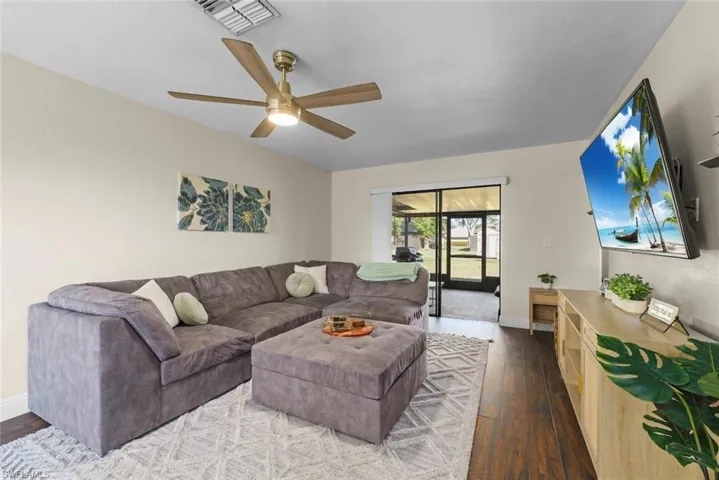 Living room featuring ceiling fan and wood-type flooring