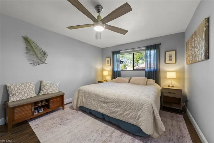 Bedroom with dark hardwood / wood-style floors and ceiling fan
