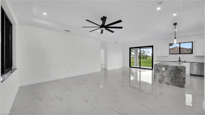 Unfurnished living room with light marble finish floors and recessed lighting