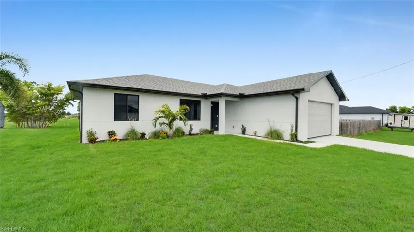 Single story home with an attached garage, concrete driveway, a shingled roof, and stucco siding