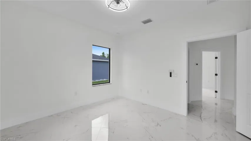 Empty room with light marble finish floors and baseboards