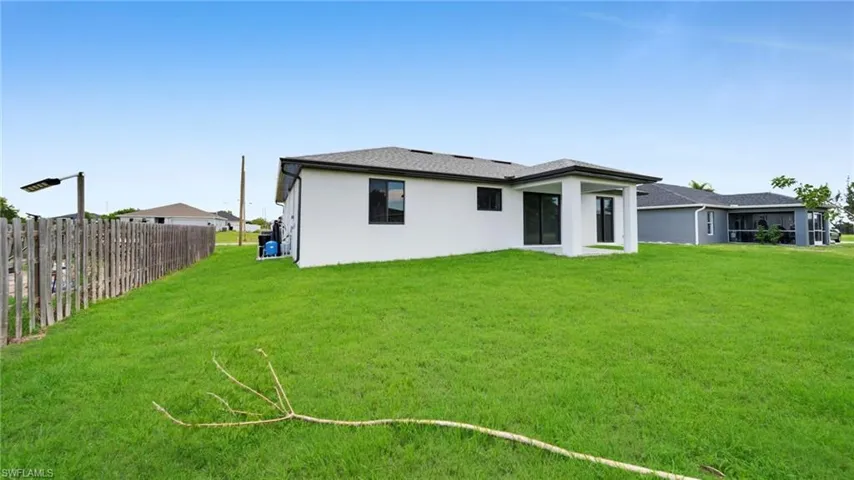 Back of property with stucco siding and a patio area