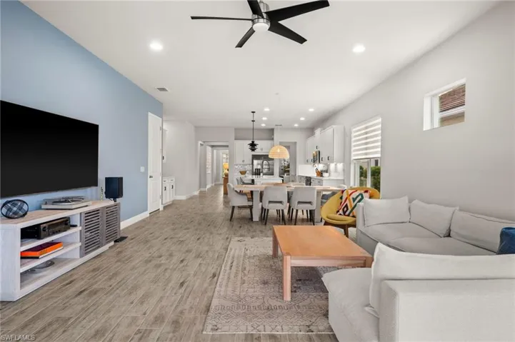 Living area with a ceiling fan, recessed lighting,  tile floors, and healthy amount of natural light