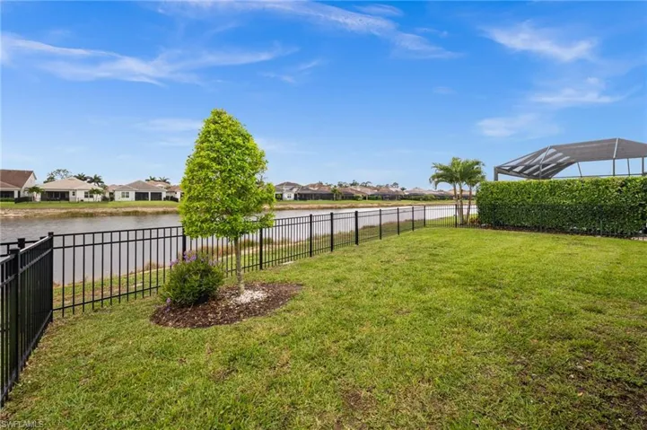 Fenced backyard with a residential view and a water view
