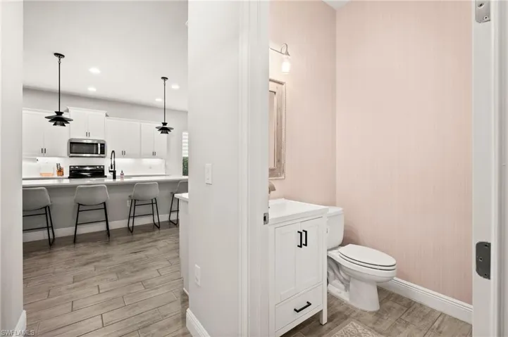Bathroom with vanity, wood finish tile floors, and recessed lighting