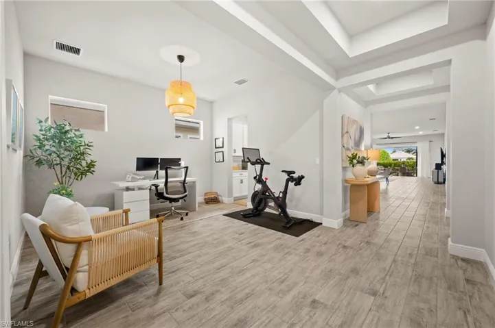 Spacious interior featuring wood-finish flooring, recessed lighting, and tray ceilings