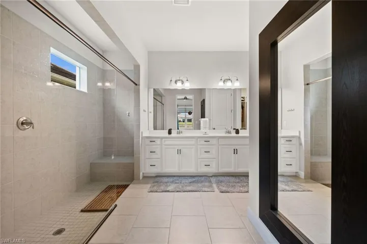 Full bathroom with a walk in shower and double vanity