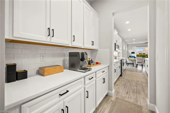 Kitchen with white cabinets, recessed lighting, tile floors, stainless steel electric range oven, and light stone counters