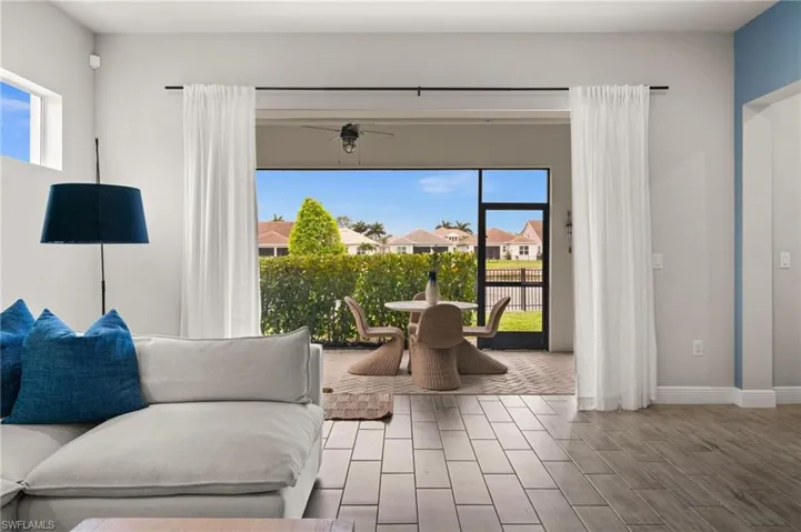 Sitting room with plenty of natural light, tile floors, and a residential view