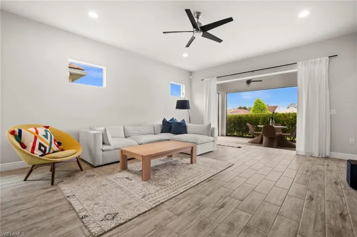 Living area with a ceiling fan, tile floors, healthy amount of natural light, and recessed lighting