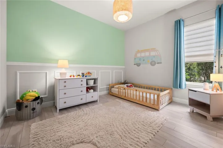 Bedroom with light, a decorative wall and wainscoting