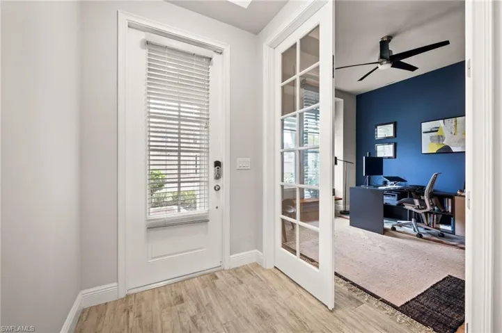White interior door with integrated blinds and a smart lock