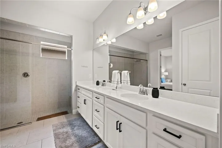 Ensuite bathroom with double vanity and a walk in shower