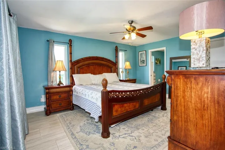 Bedroom with a ceiling fan and light wood-style floors