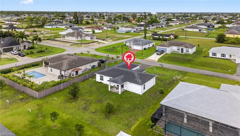 Aerial view of residential area featuring a pool