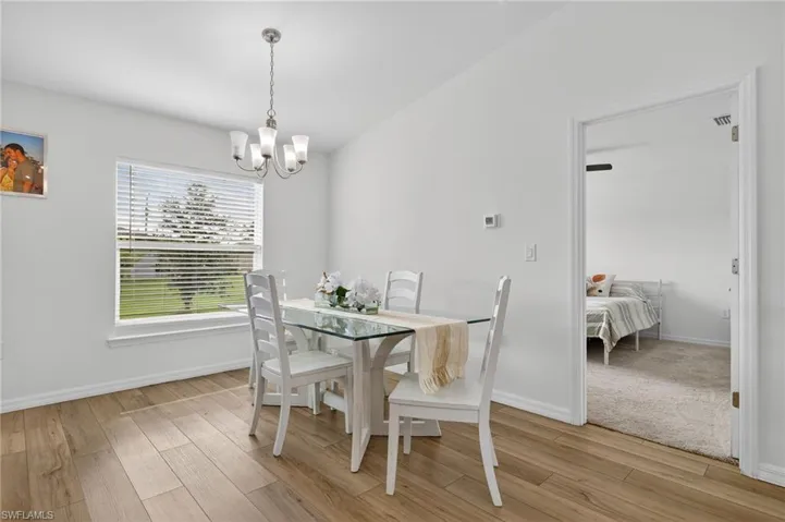 Dining space featuring a chandelier and light wood-style flooring