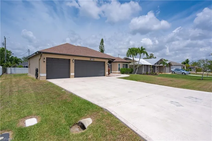 Ranch-style home with concrete driveway, stucco siding, and an attached garage