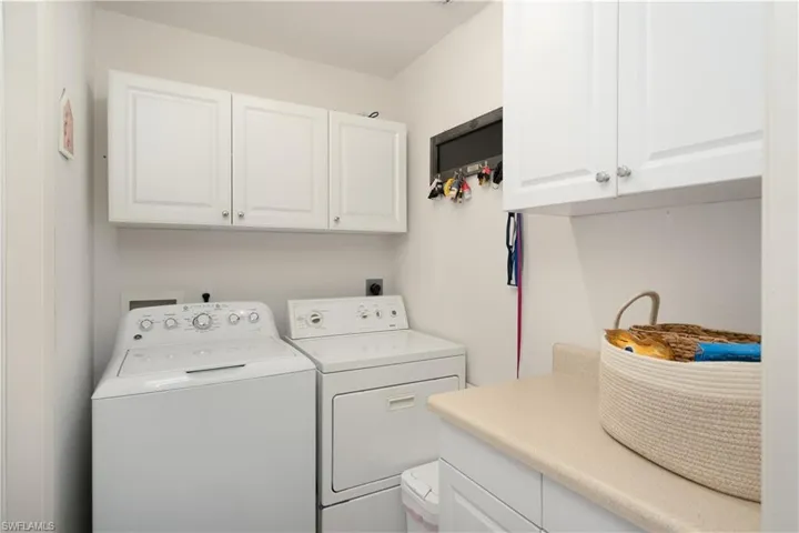 Washroom with separate washer and dryer and cabinet space