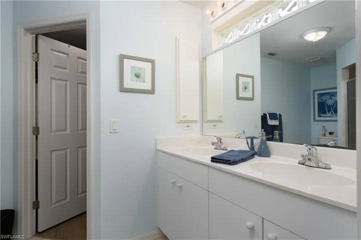 Bathroom featuring double vanity and toilet