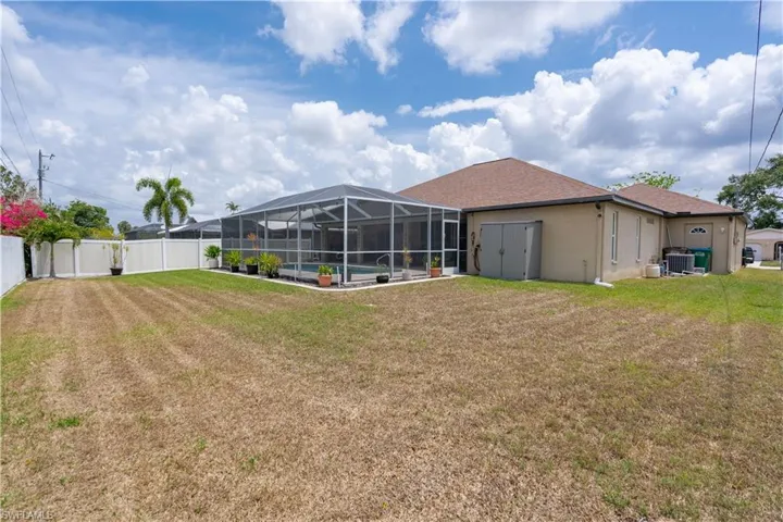 View of yard featuring an outdoor pool, a lanai, a patio, and central AC