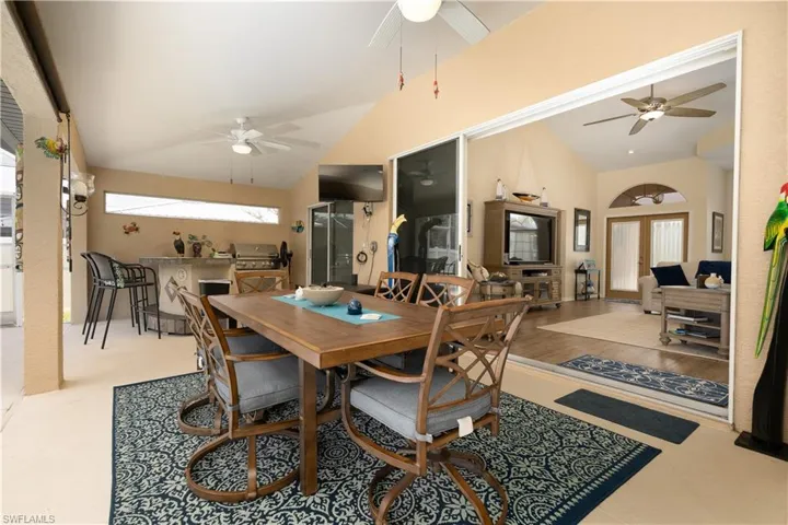 Dining space with ceiling fan and lofted ceiling