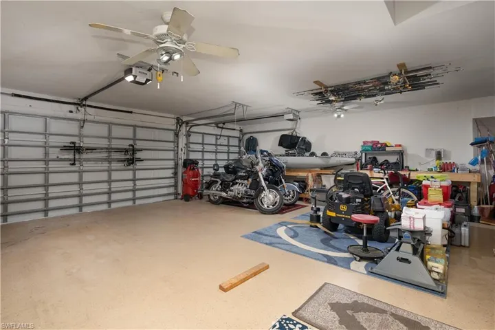 Garage featuring a garage door opener and a ceiling fan