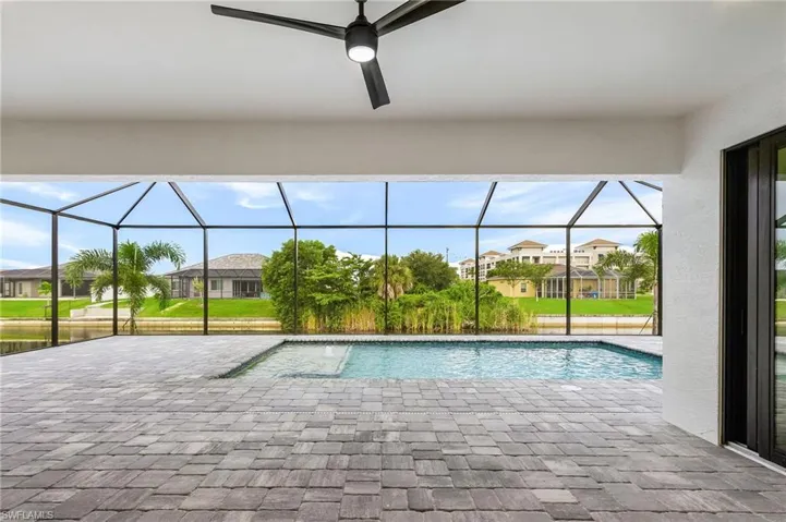 Outdoor pool with a sunroom, a patio area, a lanai, and a residential view