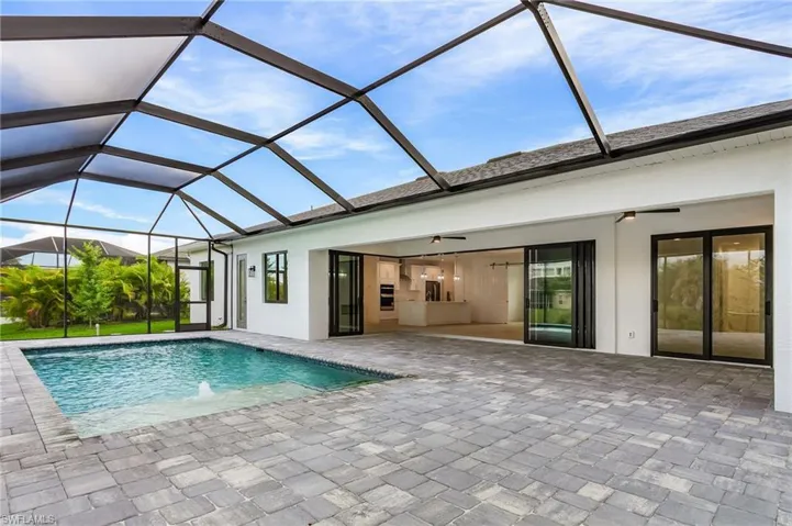 Swimming pool with a sunroom, glass enclosure, and a ceiling fan