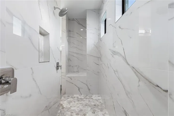 Bathroom with a marble finish shower