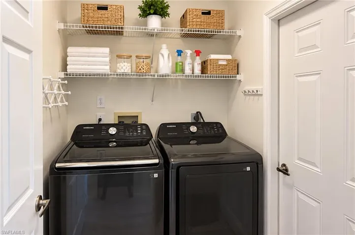 Dedicated laundry area featuring wire shelving