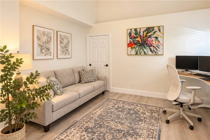 Recessed ceiling, neutral wall tones, wood-finish flooring, paneled interior door, built-in desk