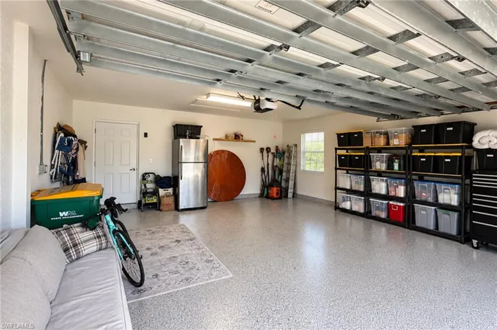 Epoxy-coated flooring, white painted walls, and integrated fluorescent lighting