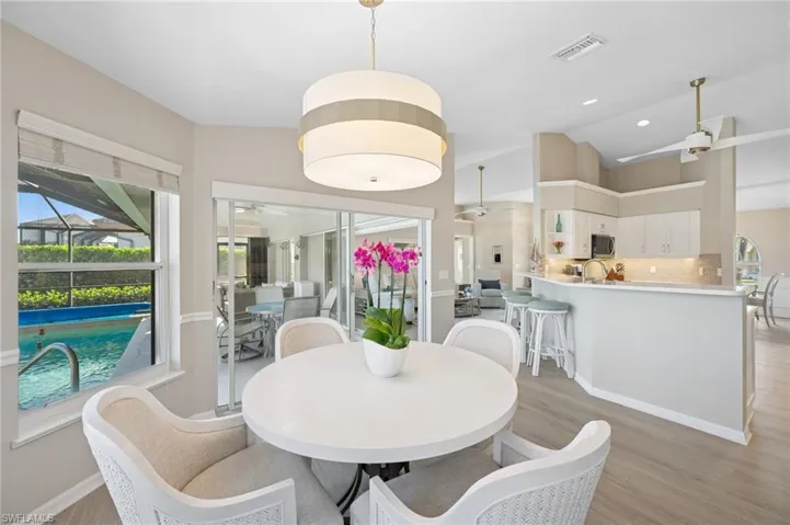 Dining room featuring visible vents, a ceiling fan, plenty of natural light, and light wood-style floors