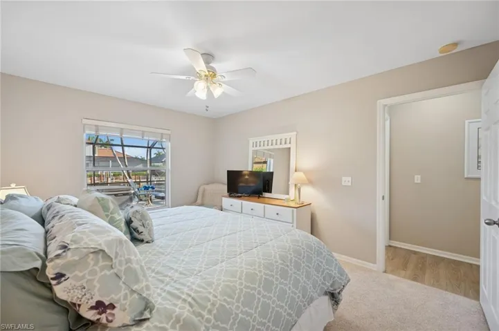 Bedroom with ceiling fan, baseboards, and carpet floors