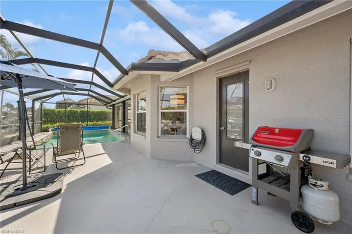 View of patio / terrace with area for grilling, an outdoor pool, and a lanai