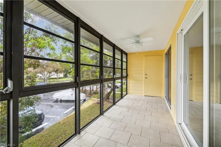 Unfurnished sunroom with ceiling fan