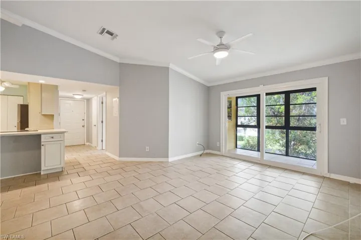 Unfurnished living room featuring visible vents, ceiling fan, and vaulted ceiling