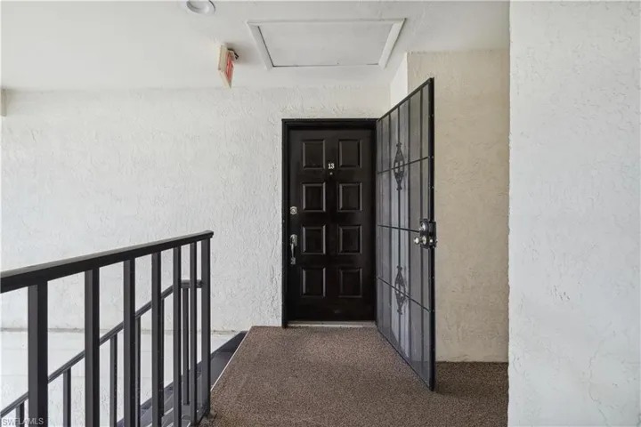 Entrance to property featuring stucco siding