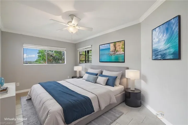 Tiled bedroom featuring ornamental molding, baseboards, and a ceiling fan