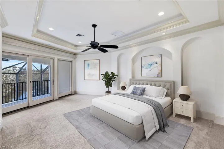 Spacious Primary Bedroom with private balcony, tray ceilings, crown molding and recessed lighting!- Virtually Staged