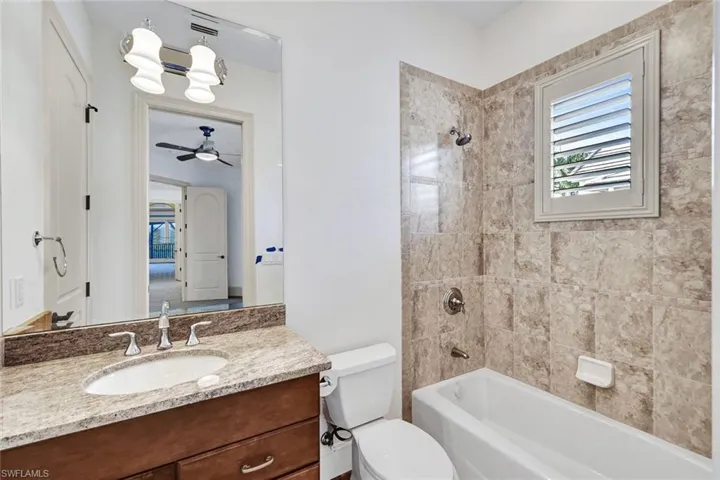 Guest bathroom #1 with tub and shower combination and plantation shutter window!