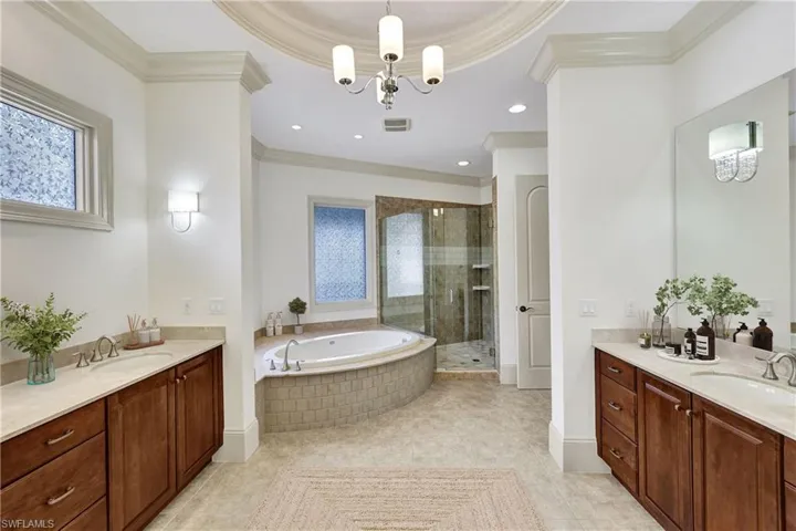 Primary bathroom with double vanities, soaking tub and walk-in shower! - Virtually staged!