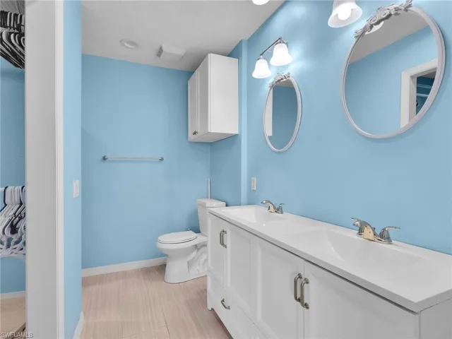Primary Ensuite Bathroom with Dual Sinks and Updated Vanity with a Quartz Counter