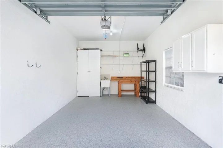 Oversized garage with a new epoxy floor and storage cabinet