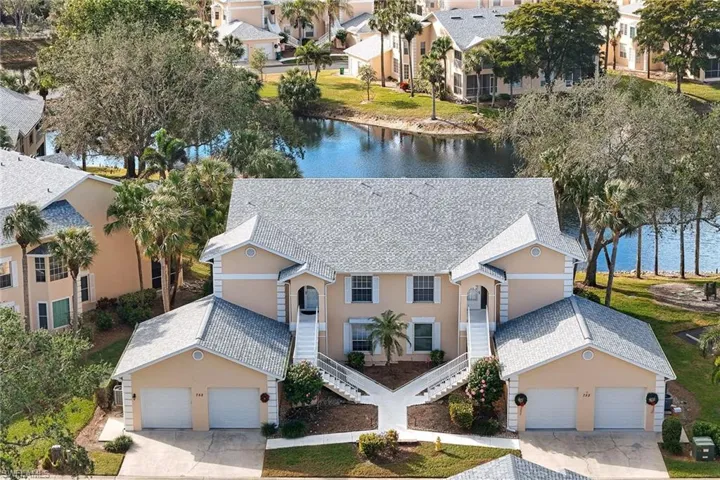 Lakefront coach home in an intimate four-residence building featuring an oversized attached garage