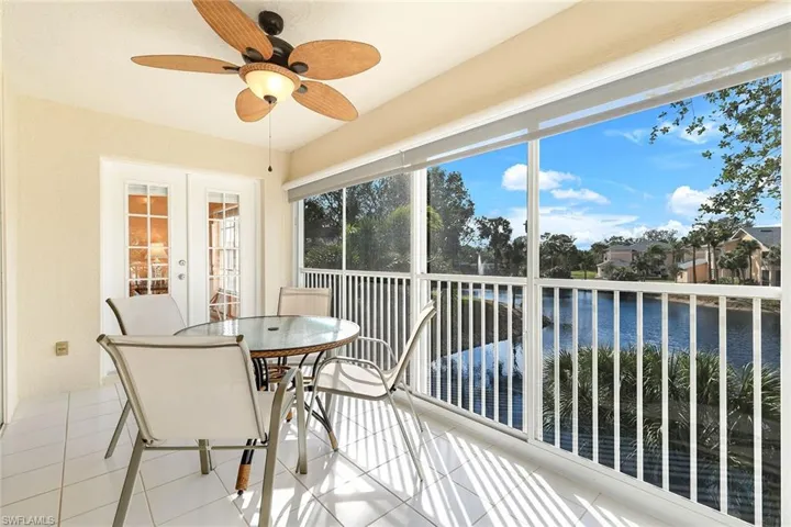 Glass-enclosed sunroom opens to the breezes, ideal for indoor-outdoor living year-round